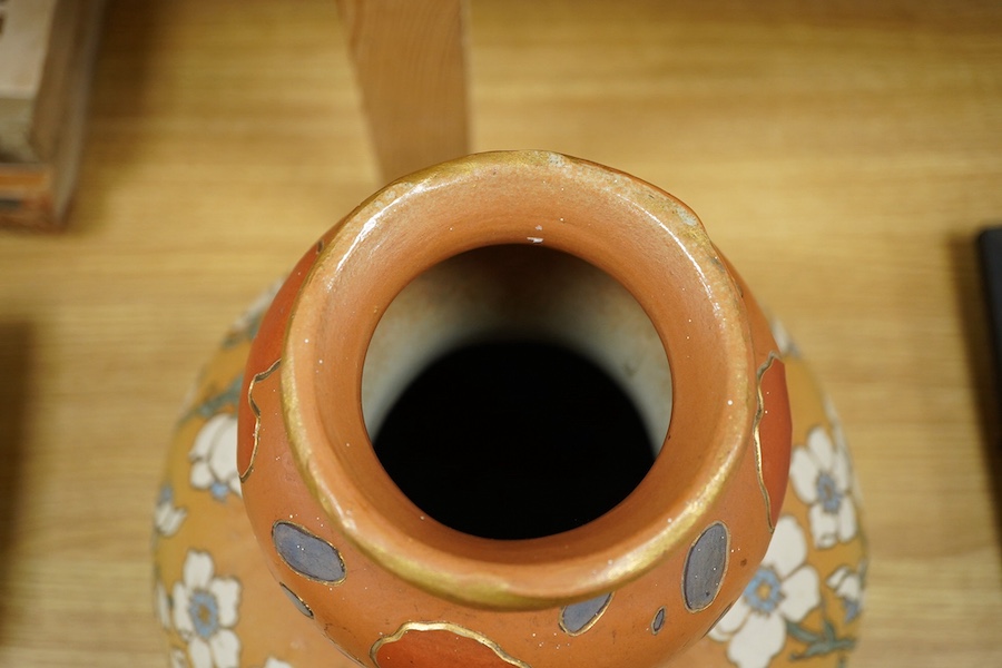 A Mettlach stoneware floral vase, impressed marks, 36cm high. Condition - fair/good